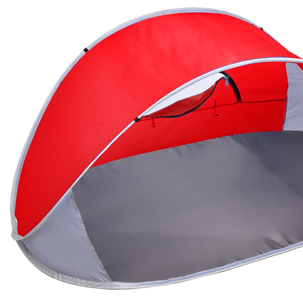 Mountvie Pop Up Tent in red color, spacious enough for 4 people, set up on a beach with a carry bag beside it.